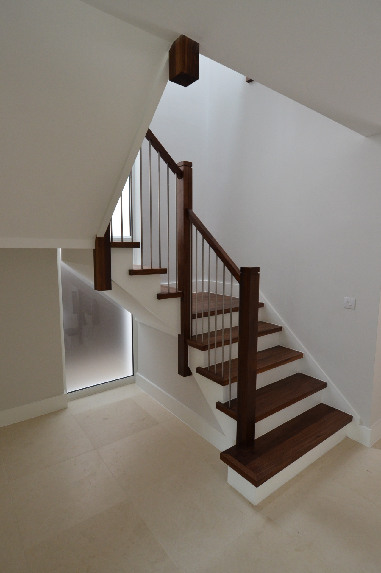 wooden U-bent Cut string stair case with iron balustrades