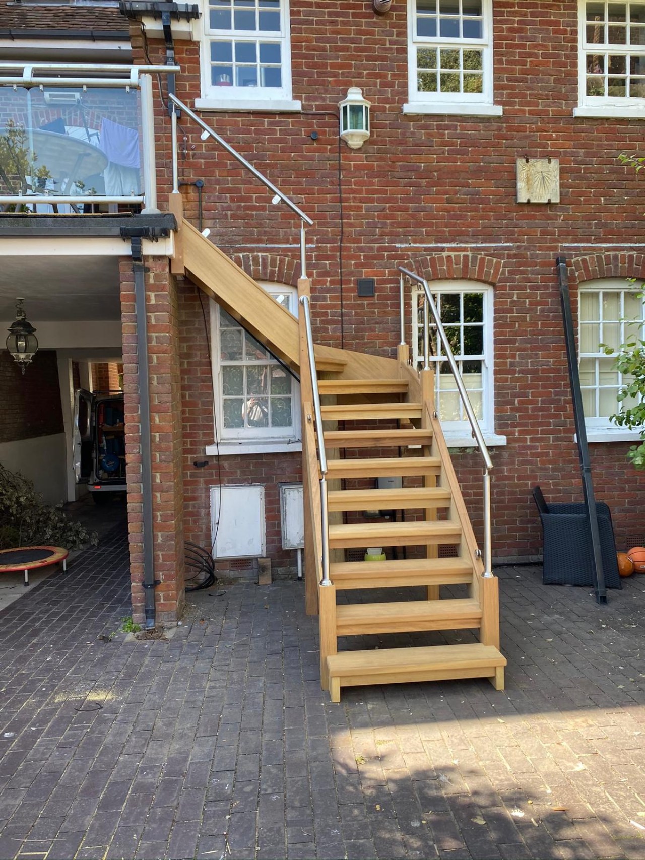 external wooden staircase with metal handles