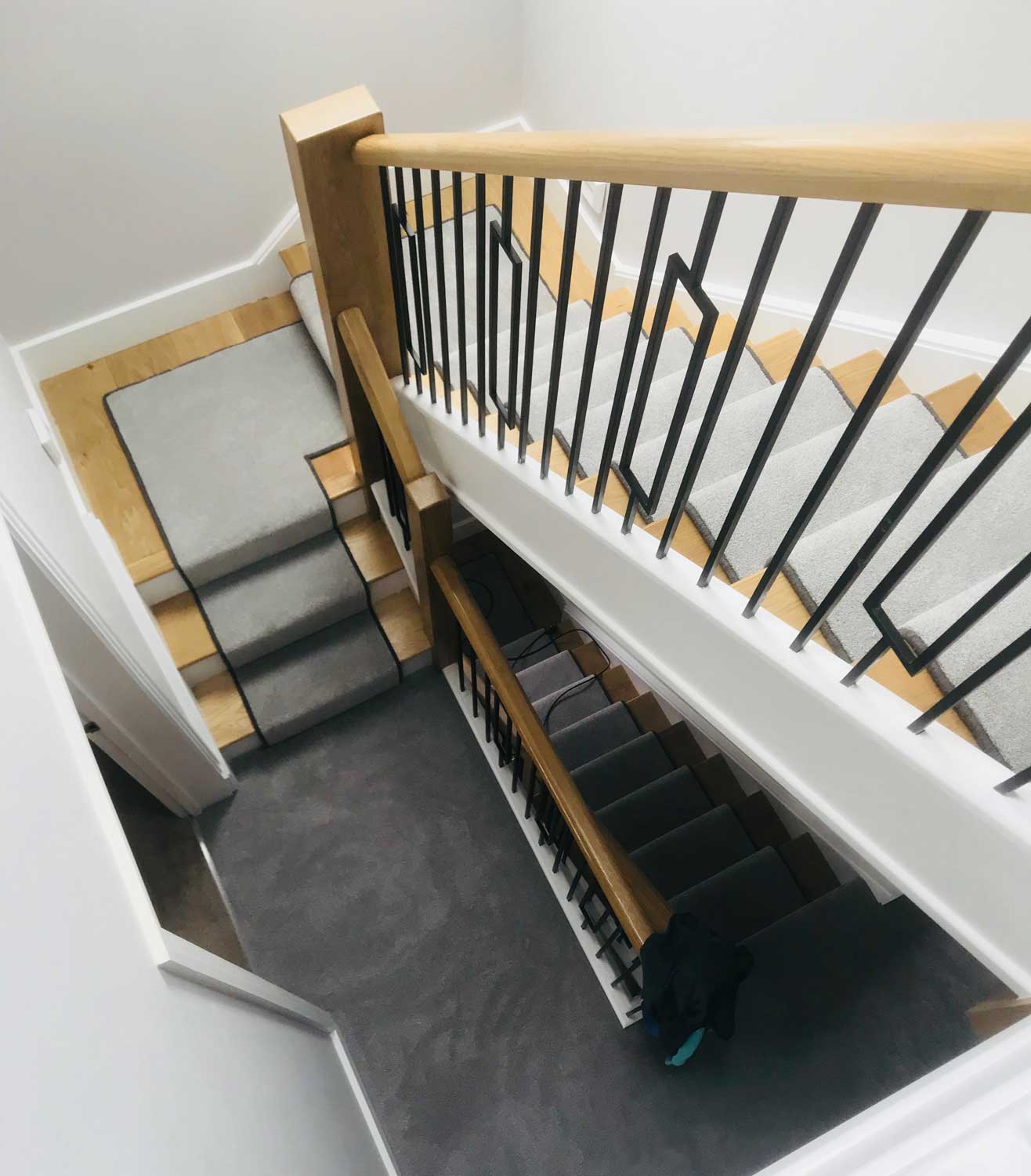 contemporary U-shaped staircase with metal spindles