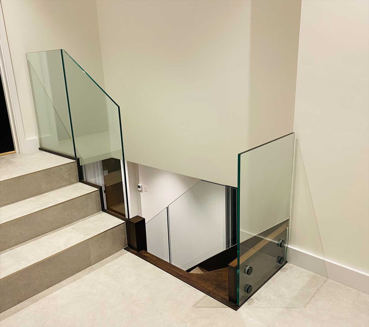 modern L-bent staircase with glass balusters