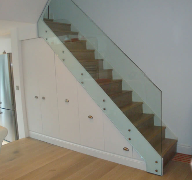 straight stairs with glass balusteres and storage