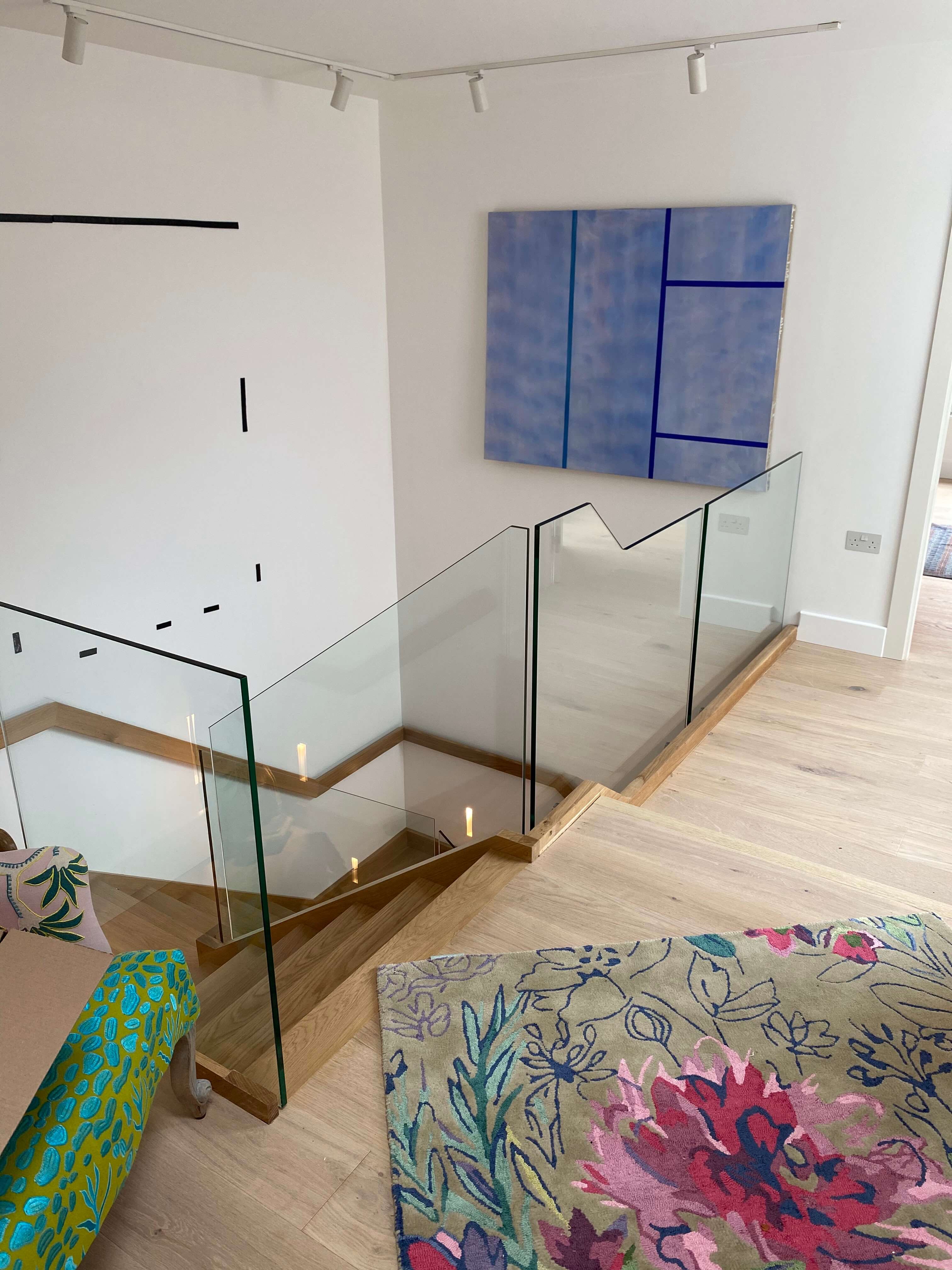 Contemporary L-bent staircase with glass balusters