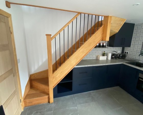 Metal spindles staircase with kitchen underneath
